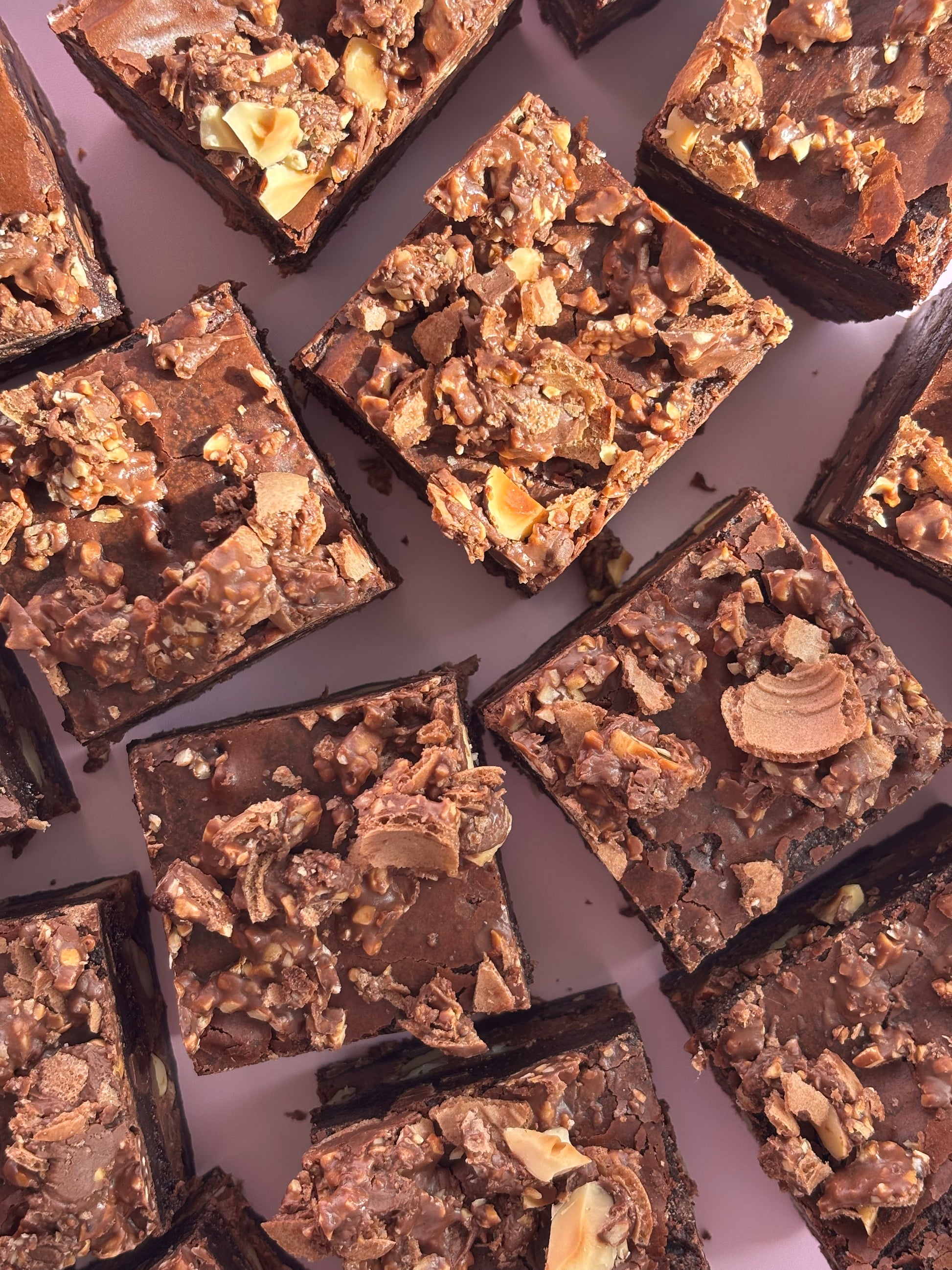 Fudgy chocolate brownies stuffed with Nutella and hazelnuts, and topped with crushed Ferrero Rochers.