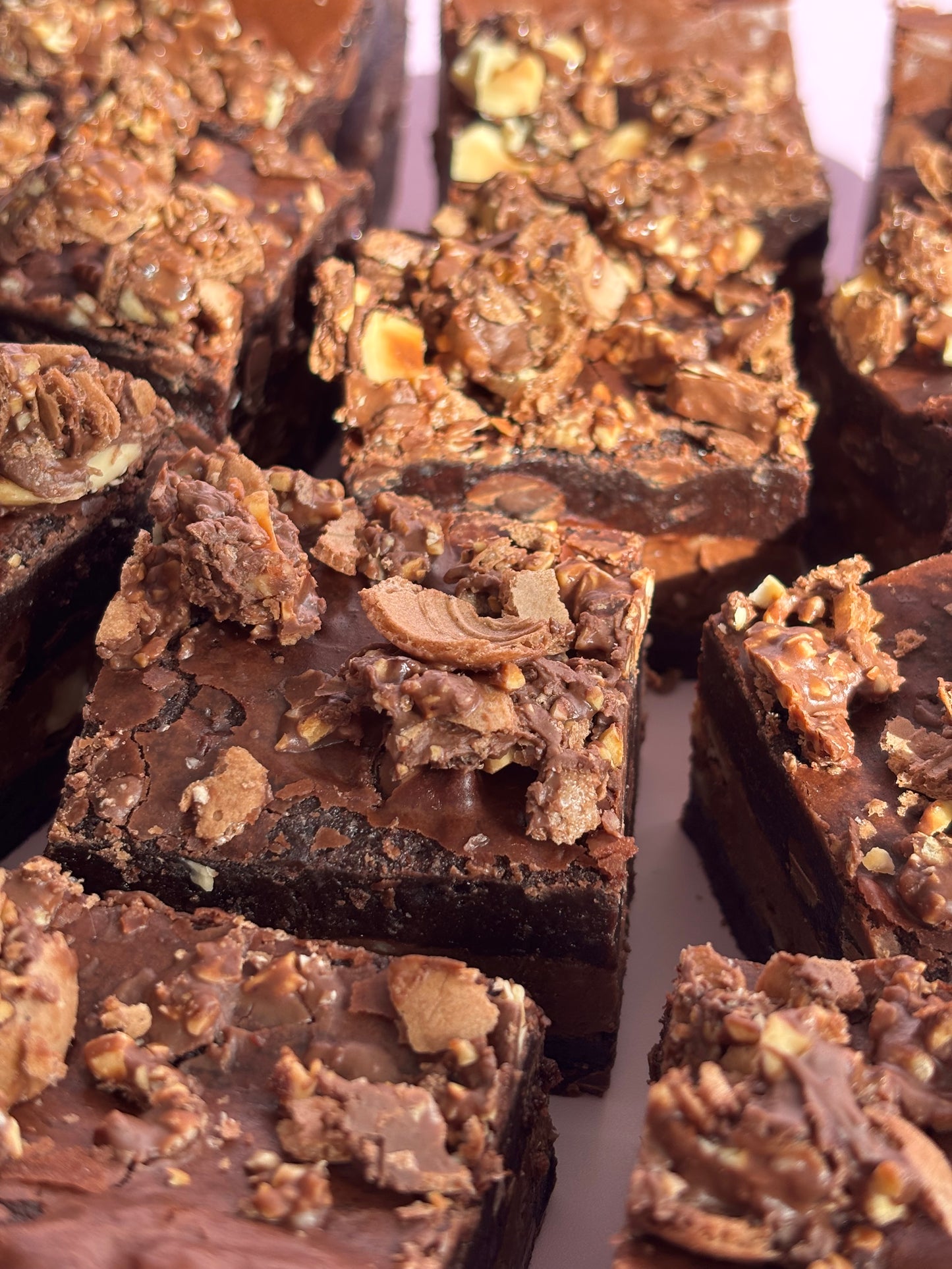 Fudgy chocolate brownies stuffed with Nutella and hazelnuts, and topped with crushed Ferrero Rochers.
