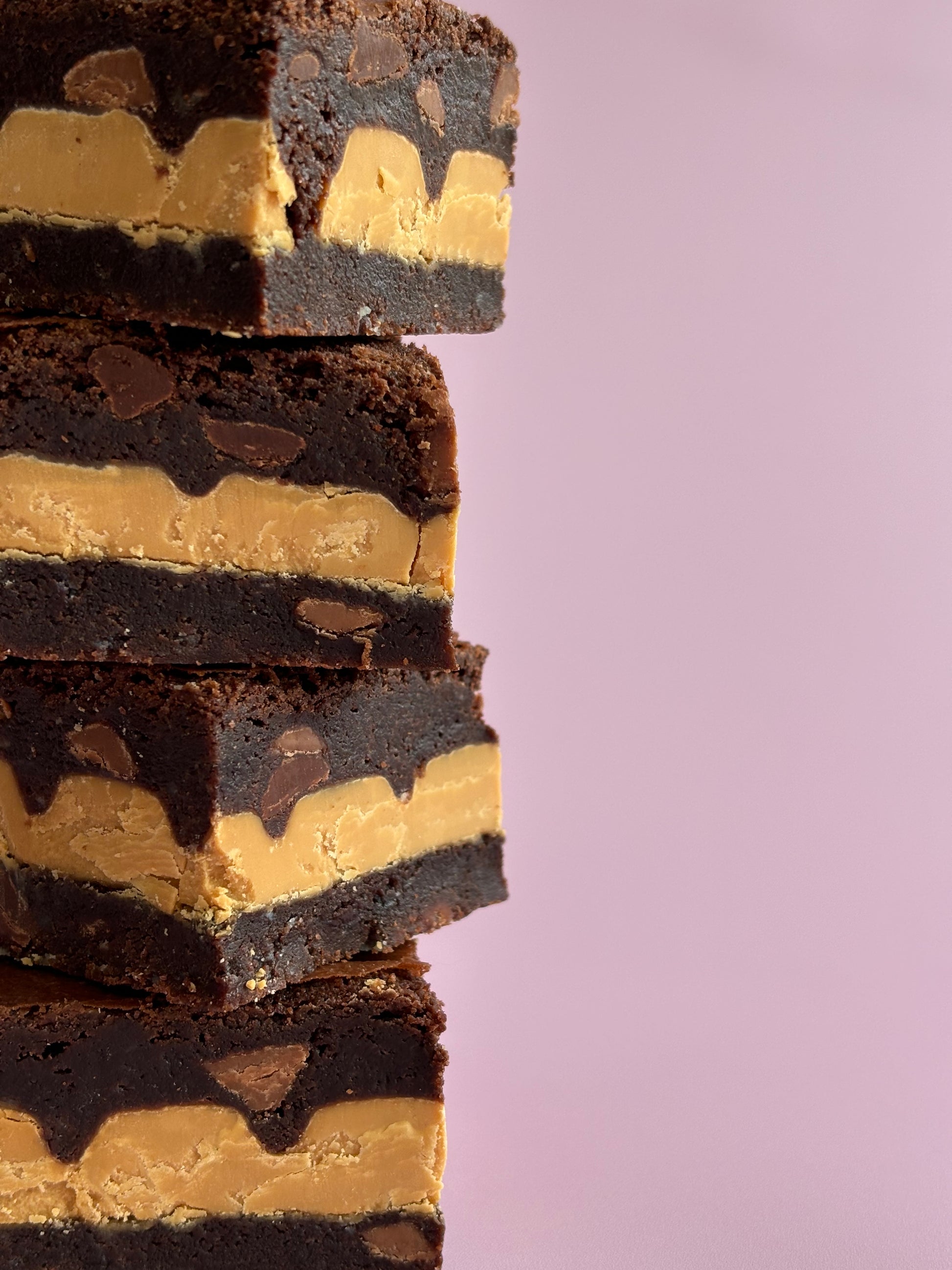 Fudgy gluten-friendly chocolate brownies stuffed with Caramilk chocolate blocks