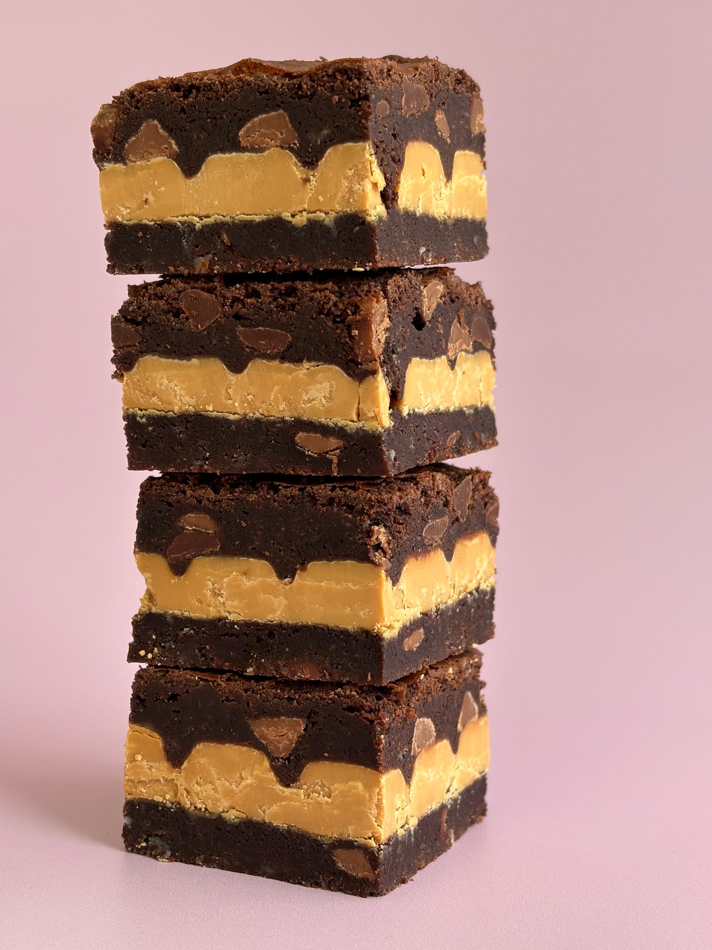 Fudgy gluten-friendly chocolate brownies stuffed with Caramilk chocolate blocks