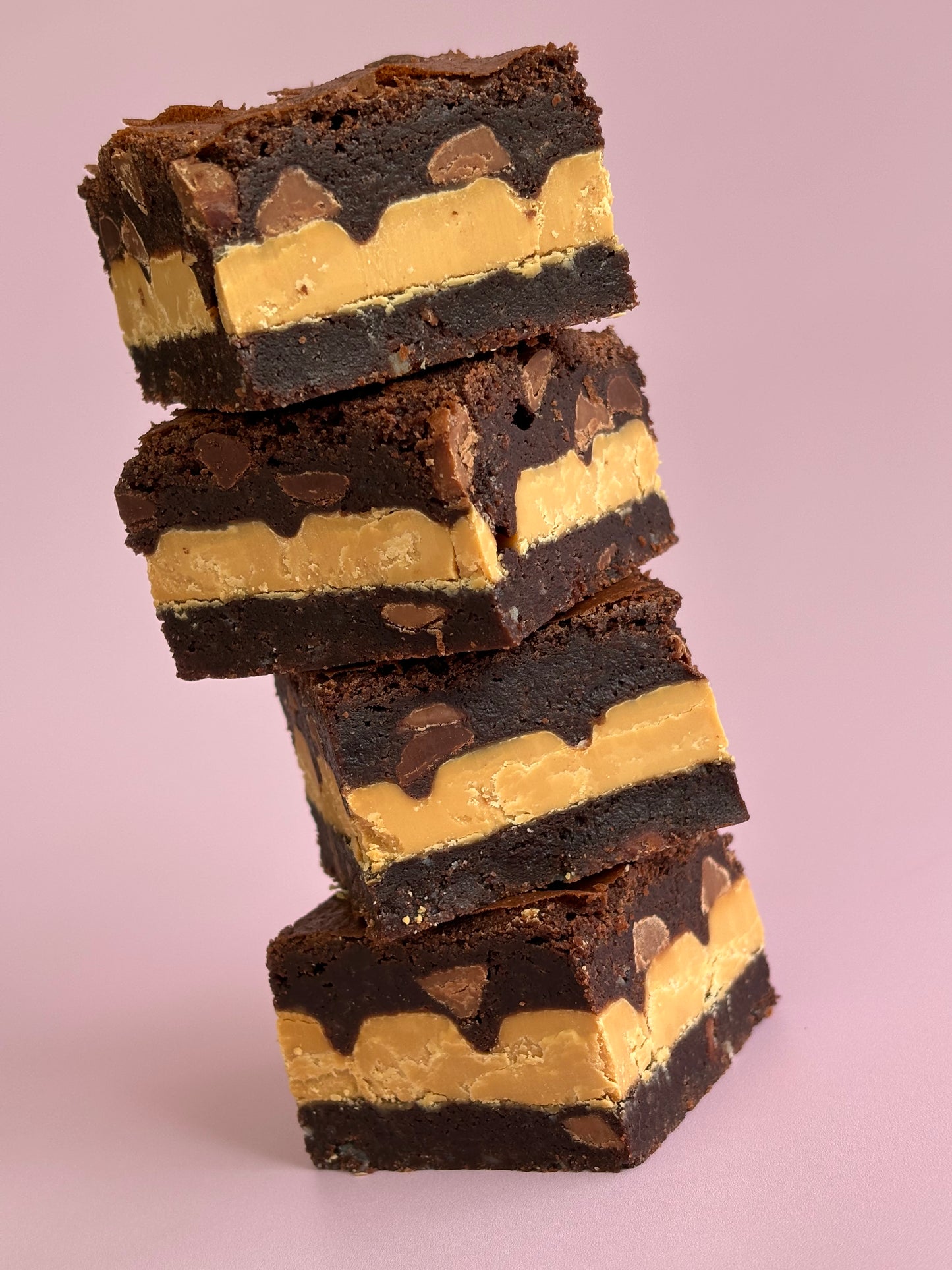 Fudgy gluten-friendly chocolate brownies stuffed with Caramilk chocolate blocks