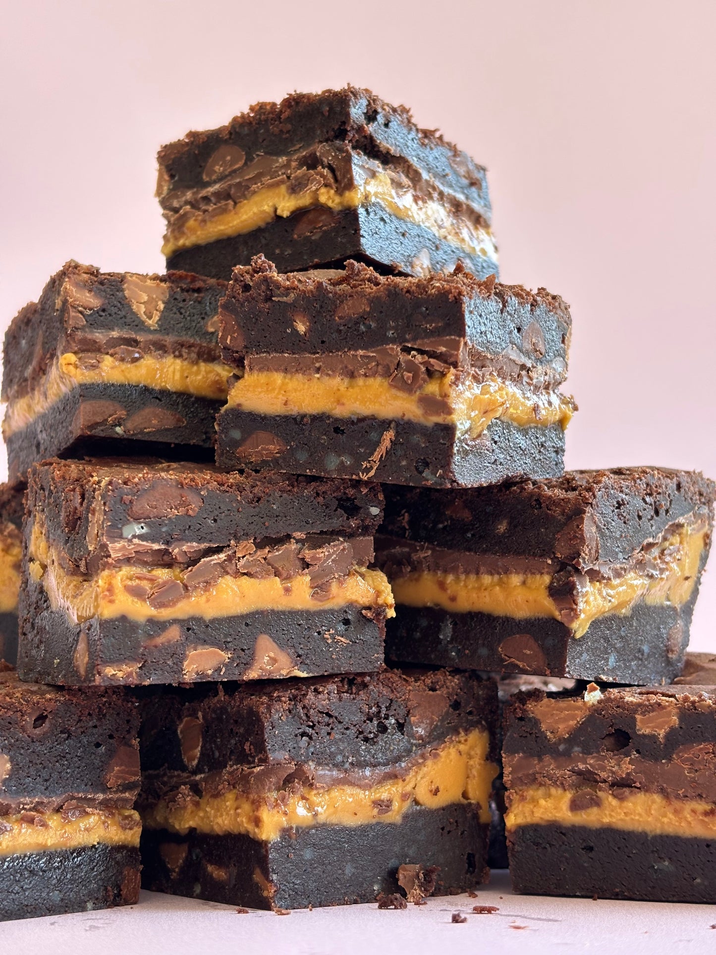 Decadent chocolate gluten-friendly brownies stuffed with a layer or milk chocolate and gooey peanut butter