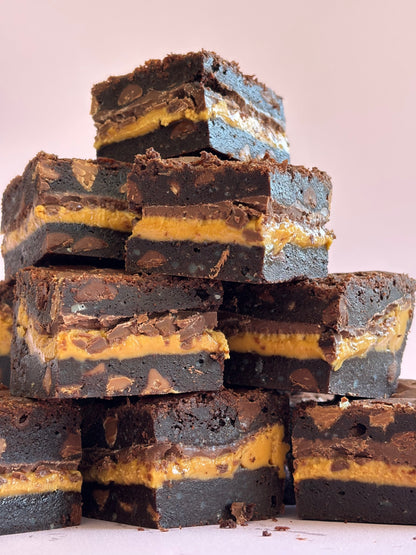 Decadent chocolate gluten-friendly brownies stuffed with a layer or milk chocolate and gooey peanut butter