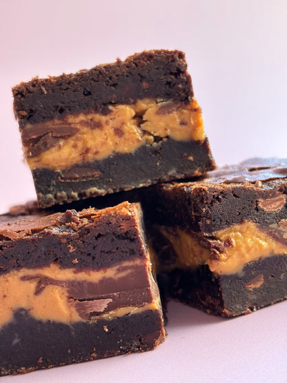 Decadent chocolate gluten-friendly brownies stuffed with a layer or milk chocolate and gooey peanut butter