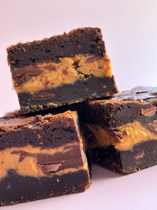 Decadent chocolate gluten-friendly brownies stuffed with a layer or milk chocolate and gooey peanut butter