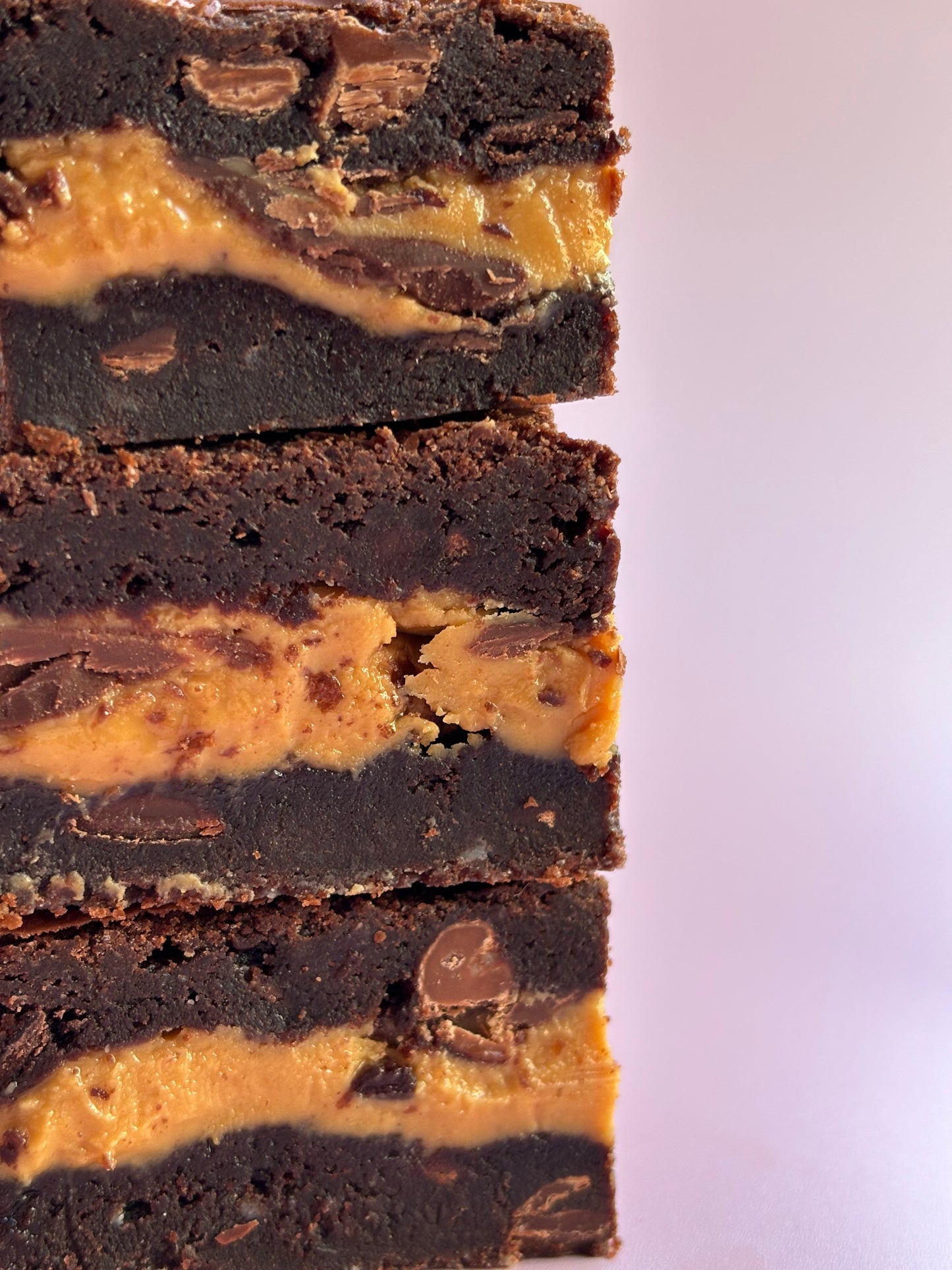 Decadent chocolate gluten-friendly brownies stuffed with a layer or milk chocolate and gooey peanut butter