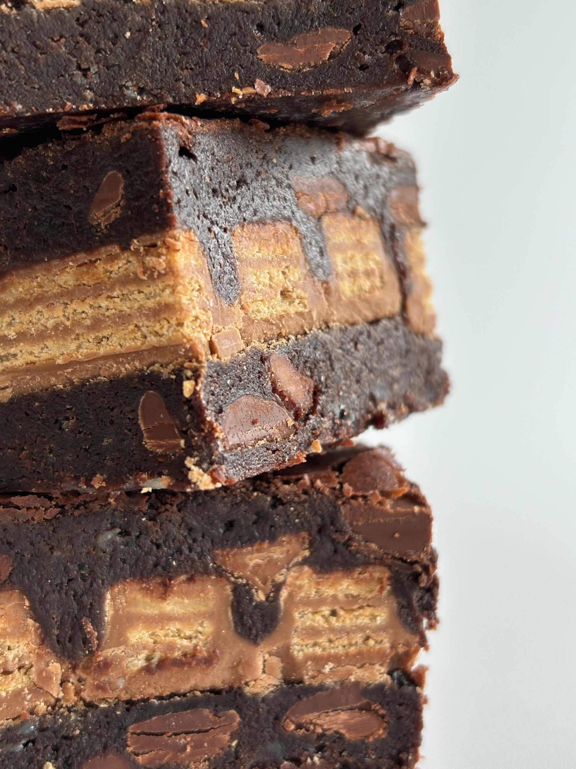 Fudgy chocolate brownies stuffed with a layer of KitKats.