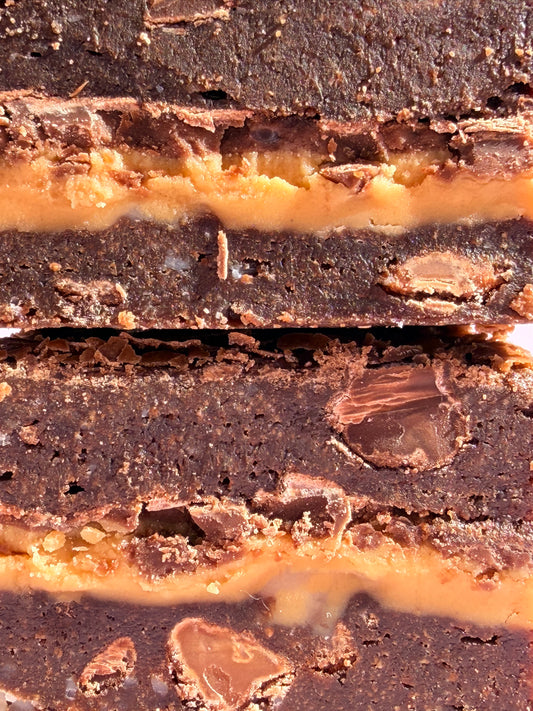 Decadent chocolate gluten-friendly brownies stuffed with a layer or milk chocolate and gooey peanut butter