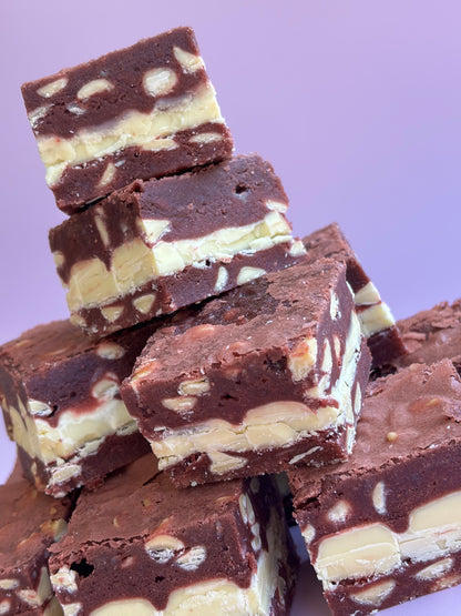 Fudgy red velvet brownies with white chocolate chips and stuffed with white chocolate bars