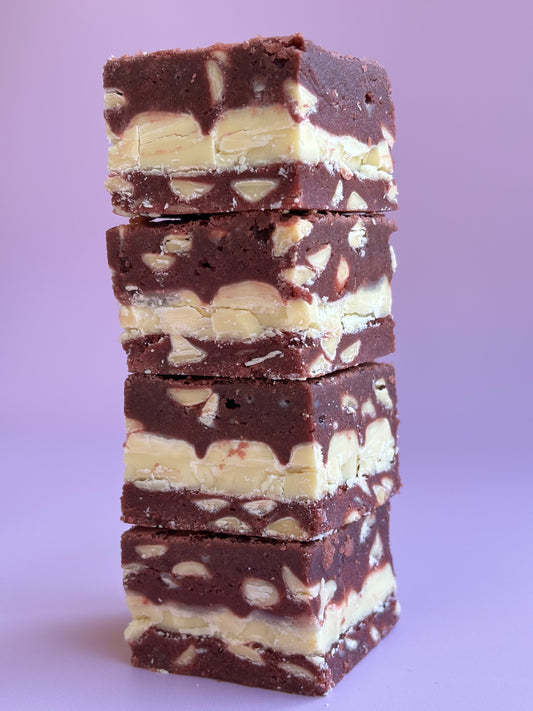 Fudgy red velvet brownies with white chocolate chips and stuffed with white chocolate bars