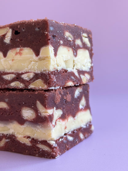 Fudgy red velvet brownies with white chocolate chips and stuffed with white chocolate bars